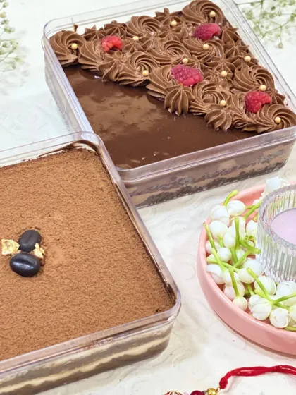 A side-by-side view of my two most popular dessert tubs for Rakhi: the classic Tiramisu and the indulgent Raspberry Chocolate. Both are creamy, layered, and entirely eggless.