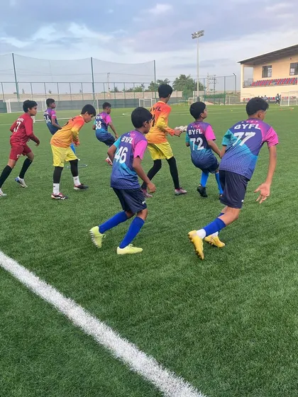 Players navigating through cones during an agility drill, a staple of our training regimen.