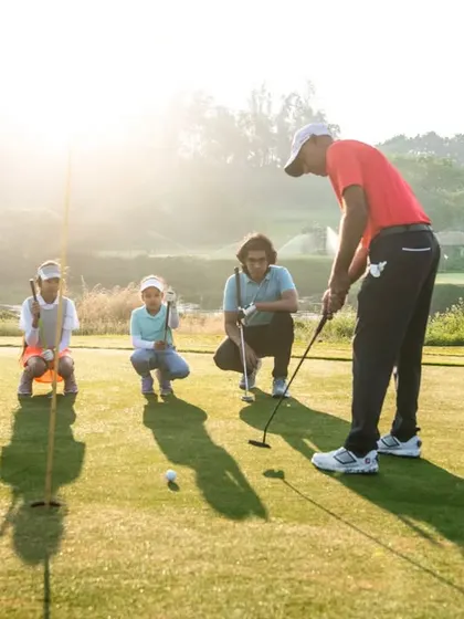A group of young learners watches as our coach demonstrates proper putting technique. Our summer camps are a great way for kids to learn golf in a supportive group setting.