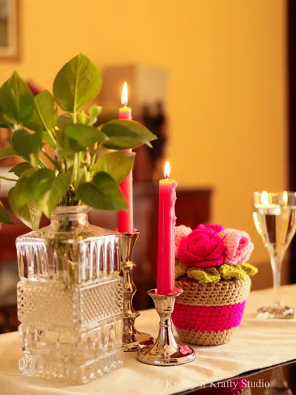 My pot of crochet roses styled with fresh greenery and candles. The combination of handmade and natural elements creates a beautiful balance.
