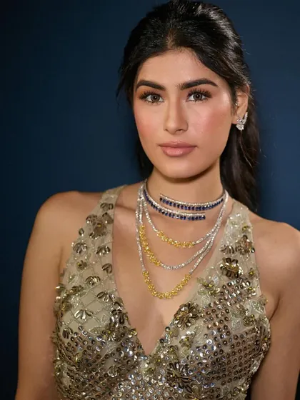 A close-up of the cocktail look, showing the layered necklaces and soft, warm makeup. This demonstrates how to create a cohesive look where the makeup, hair, and styling all work together.