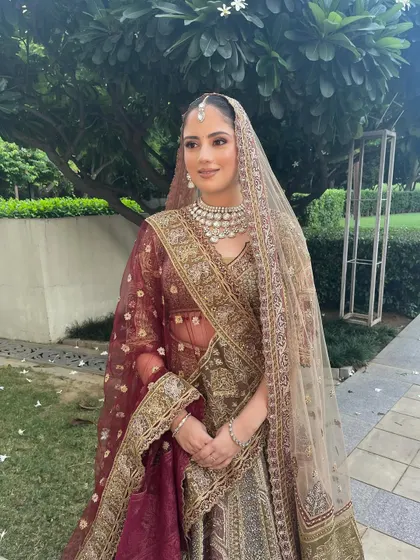 The complete bridal look is a picture of grace and elegance. The soft makeup perfectly complements the intricate details of her pastel lehenga.