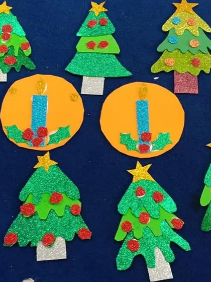 A collection of glittery Christmas tree and candle ornaments made from paper. Simple, fun, and perfect for little hands to create.