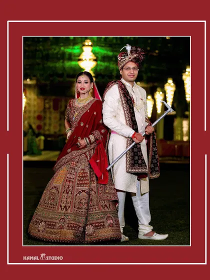A classic full-length portrait of the couple in their wedding attire, posing in a beautifully lit garden.