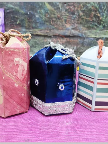 A collection of handmade gift boxes with various embellishments. Our workshops cover everything from box construction to decoration.