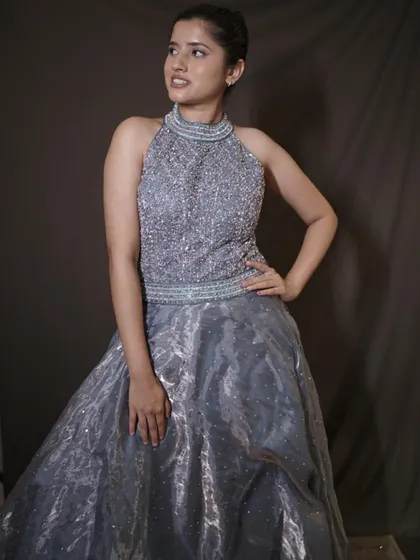 This silver-grey ball gown with its heavily embellished halter-neck bodice is designed to make you the center of attention. It's the perfect outfit for your main character moment.