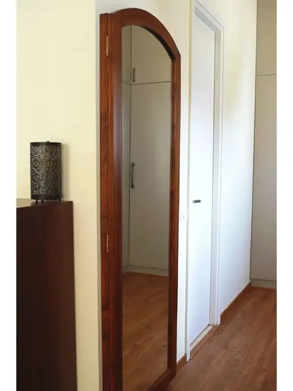 The full-length swing-out mirror, custom-made for a yoga teacher to use during online classes. It's a perfect example of design tailored to a client's lifestyle.