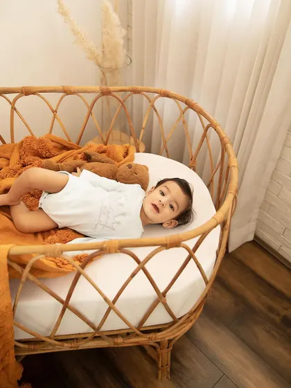 Just relaxing in a cozy crib. These lifestyle shots capture your baby in a natural, comfortable setting, creating authentic portraits.