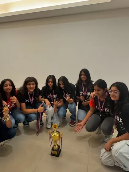 Posing with the prize. The team gathers around their trophy after a hard fought tournament win.