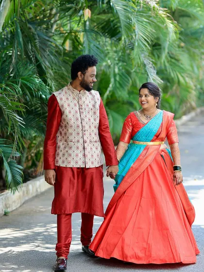 My beautiful bride on her Varapooja. This look features a vibrant half-saree in orange and blue, with makeup that is bright and festive.