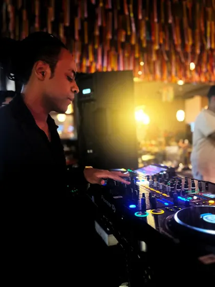 Adjusting the levels on my Pioneer mixer during a live set. It's all about the fine details to make sure the sound is just right.