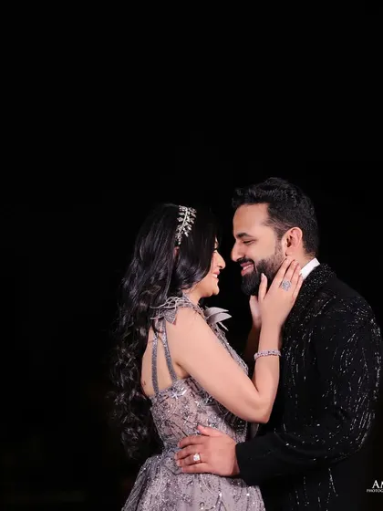 An intimate embrace that feels both posed and natural. The focus is on their connection, creating a beautiful and romantic portrait from their reception.