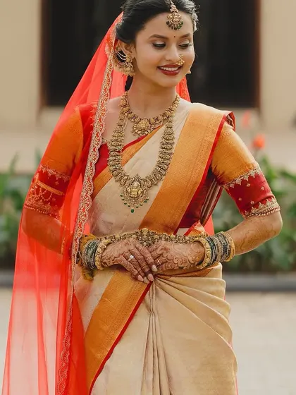 A smiling portrait of Brunda, her traditional bridal look is both elegant and joyful.