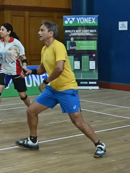 An adult mixed-doubles pair in action during the GD Birla Memorial Masters Tournament, perfect for those who enjoy competitive social play.