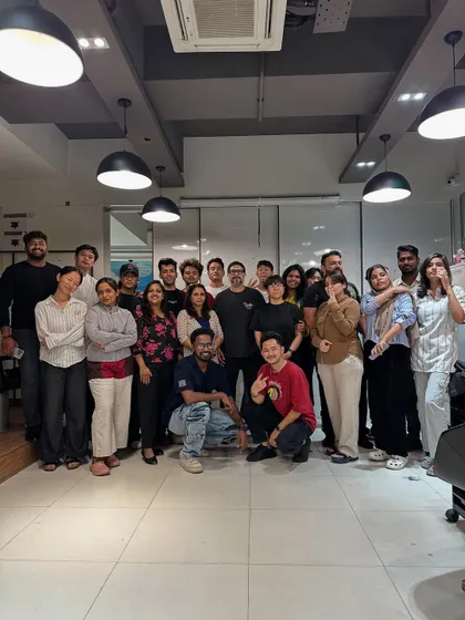 A group photo from an advanced haircut workshop. We foster a collaborative environment where students learn together and support each other's growth.