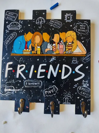 For the fans of the show, a "Friends" themed keyholder. This hand-painted piece features iconic quotes and imagery from Central Perk, making it a fun and nostalgic addition to your home.