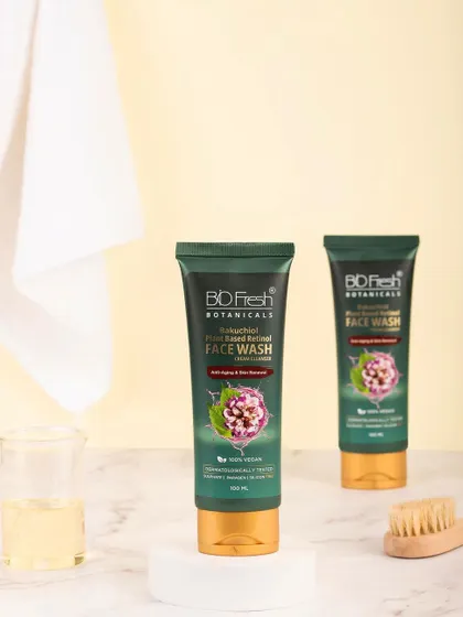 A clean, bathroom-setting shot of Biofresh Botanicals' face wash. The use of a white towel and simple props creates a fresh, hygienic, and minimalist look.