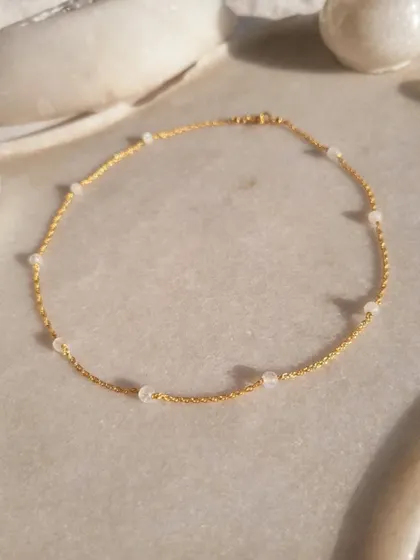 A close-up of the 'apati' Rainbow Moonstone ball choker. I love working with this stone for its ability to bring balance, harmony, and inner confidence.