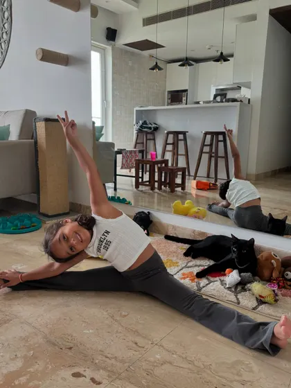 Our 5-year-old superstar Mia nailing her splits, with our cat Bro casually photobombing. Flexibility and fun go hand-in-hand here.