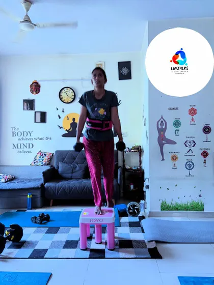 A client performs step-ups with dumbbells, a great exercise for building single-leg strength and improving balance.