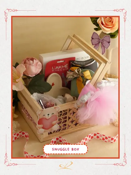 The 'Snuggle Box' is a cozy and cute option. This wooden crate hamper is filled with skincare items like a Lakme face mask and other pampering products, perfect for a relaxing day in.