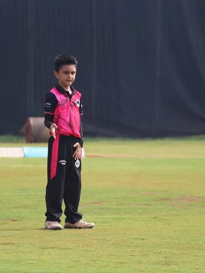 A young boy sets his field during a U-10 Dasara Cup game, learning leadership skills early.