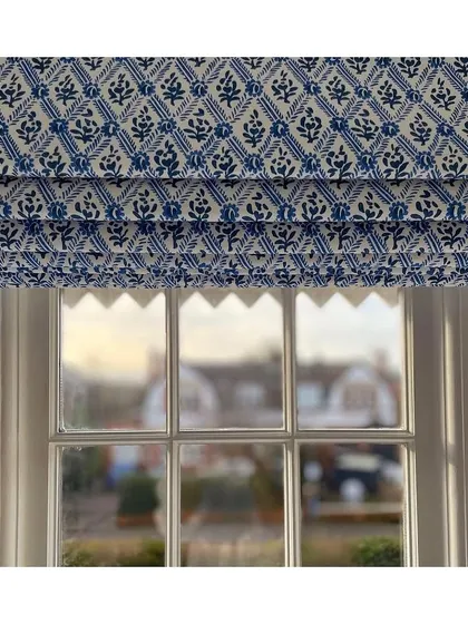 Blue and white prints are a timeless classic. These Roman blinds, made from a 'Designers Guild' fabric, bring a touch of colonial-inspired charm and a crisp, clean look to the window.