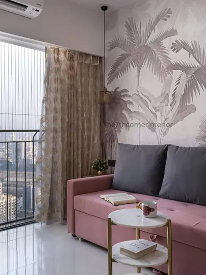 The guest bedroom is designed to be warm and welcoming. The distinctive wallpaper behind the sofa-cum-bed creates a unique aesthetic, while the open floor space allows for flexibility.