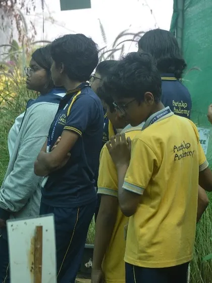 A member of my team explaining different types of plants to an engaged group of students. Our workshops are designed to be interactive and informative.