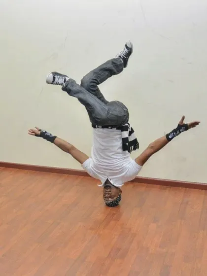 A demonstration of strength and balance with this headstand freeze. We teach you how to build up to these moves safely.