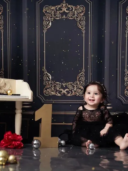 A classic and beautiful portrait from a first birthday shoot, featuring our popular white piano prop.