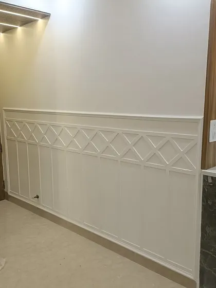 An example of classic wall molding or wainscoting. This detail adds a timeless, architectural element to hallways and living rooms, and we can customize the pattern to your liking.