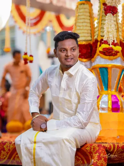 A candid portrait of the groom during the wedding ceremony, looking relaxed and happy.