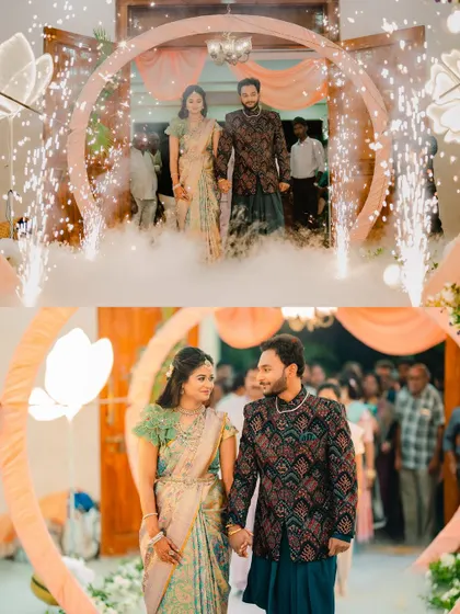The couple makes a grand entrance to their reception through a circular arch, surrounded by sparklers and smoke. It’s a magical start to an evening of celebration.