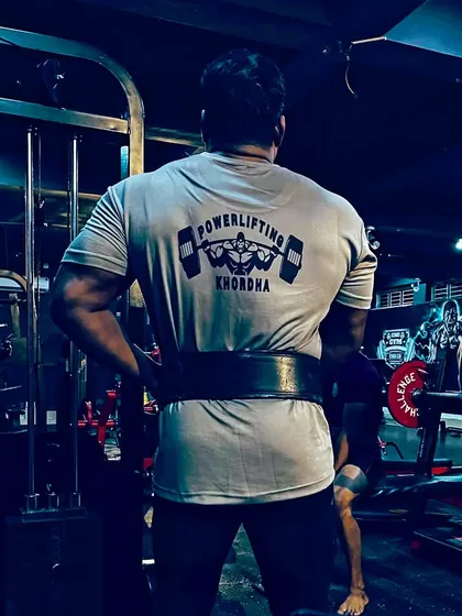 Wearing my Powerlifting Khordha shirt with pride. This back shot shows the foundation of strength built from years of heavy lifting.
