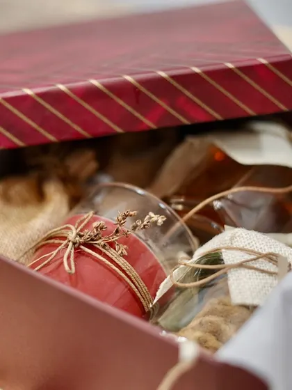 A sneak peek inside a gift box, showing how we carefully arrange items like scented candles and gourmet treats to create a delightful unboxing experience.