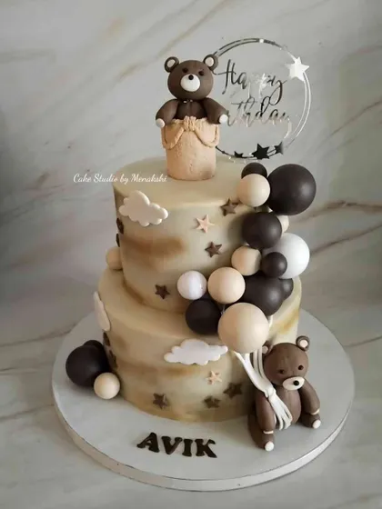 A first birthday cake for Avik in muted, neutral colors as the client requested. This two-tier cake features teddy bears, balloons, and clouds for a dreamy feel.