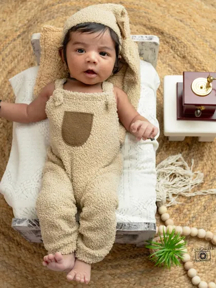 Snuggled up and cozy. This little one in a teddy bear outfit on a miniature bed is the definition of adorable. I love creating these sweet, imaginative scenes for newborn portraits.
