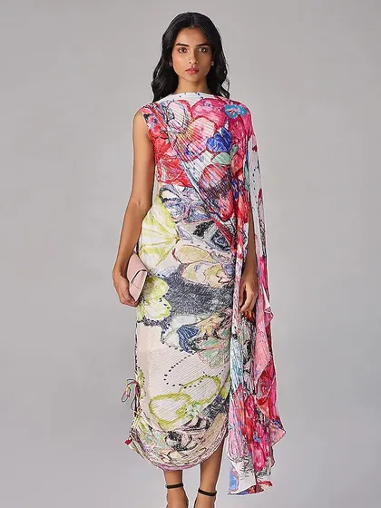 A wearable canvas. This draped dress features a vibrant, abstract floral print, transforming a simple silhouette into a piece of art.