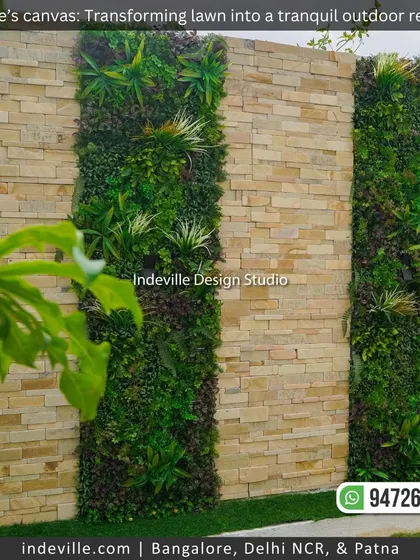 An artificial vertical garden installed on a stone-clad boundary wall. This is a great low-maintenance solution for adding a lush green texture to a backyard.