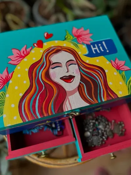 Our hand-painted jewelry box is a thoughtful and beautiful gift, perfect for Mother's Day. This one features a happy woman surrounded by flowers.