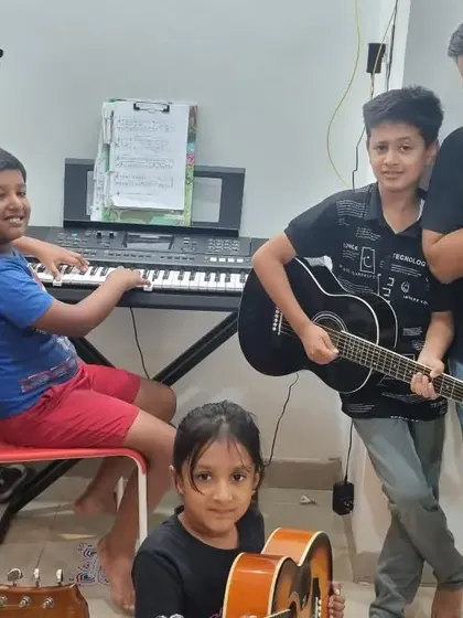 **A Band of Young Rockstars.** Look at the excitement on their faces. Jamming with their mentor and fellow students is an invaluable experience that builds teamwork and social skills.