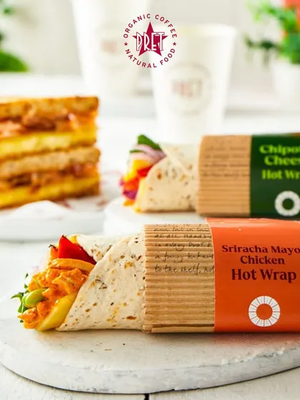 A delicious Sriracha Mayo Chicken Hot Wrap from Pret A Manger. This image showcases the fresh, natural, and convenient food options available for a quick and healthy meal.