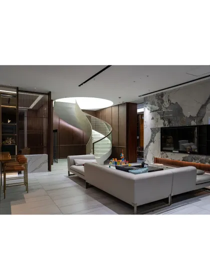 Our designs often feature architectural elements that define a space. This stunning spiral staircase acts as a functional sculpture, connecting levels while adding a significant wow-factor to the home's interior.