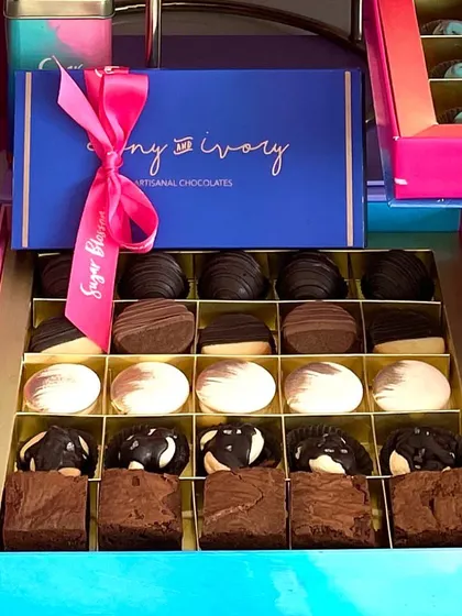 This large gift box is perfect for sharing with the whole family. It features rows of chocolate cake truffles, chocolate dipped cookies, chocolate almond rocks, and brownie bites, all from my signature collection.