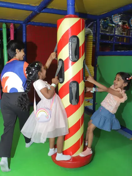 Laughter and fun around the spinning pole. Our play equipment is designed for multiple children to enjoy at once, making it perfect for energetic party groups.