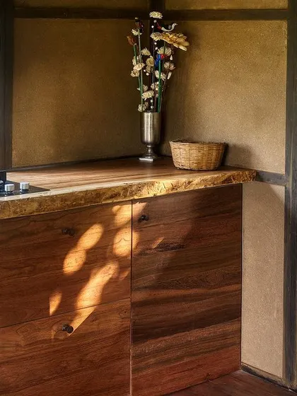The kitchenette in our prefab prototype features a live-edge wooden countertop and simple cabinetry. It shows that even in a compact, eco-friendly home, every detail can be beautiful and highly functional.