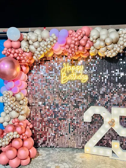 An alternate angle of the 25th birthday decor, showing how the shimmer wall beautifully reflects the light.