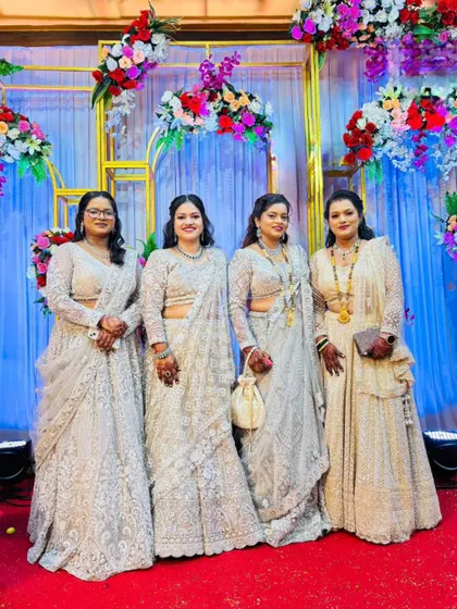 A family of beautiful ladies all dressed in coordinated white and silver outfits rented from my store for a wedding.