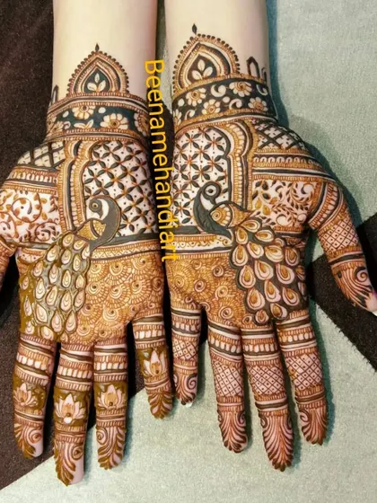 A clear photo of a symmetrical peacock design on both hands. The patterns are perfectly matched, which requires a lot of skill and precision.